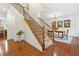 Inviting hardwood foyer with staircase, dining room, and elegant details including wainscoting at 111 Millstone Way, Canton, GA 30115