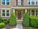 Welcoming front entrance with a classic wood door framed by manicured greenery and elegant columns at 111 Millstone Way, Canton, GA 30115