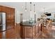 Open-concept kitchen featuring a large island, stainless steel appliances, and hardwood floors at 111 Millstone Way, Canton, GA 30115