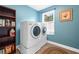 Efficient laundry room showcasing a modern washer and dryer, with shelving for storage and a window at 111 Millstone Way, Canton, GA 30115