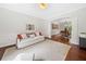 Bright living room with ample seating that opens to a dining area with elegant arched doorway and large area rug at 111 Millstone Way, Canton, GA 30115
