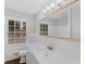 Bathroom featuring a large mirror and white tiled walls at 1110 Upper Hembree Rd, Roswell, GA 30076