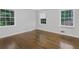 Bedroom featuring hardwood floors, neutral paint and double-hung windows at 1110 Upper Hembree Rd, Roswell, GA 30076