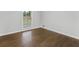 Cozy bedroom featuring hardwood floors and a bright window for natural light at 1110 Upper Hembree Rd, Roswell, GA 30076