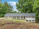 Charming one-story home featuring a light-colored facade, dark shutters, and a neatly maintained landscape at 1110 Upper Hembree Rd, Roswell, GA 30076