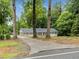 Scenic home exterior with a long driveway lined with trees, complemented by a well-maintained lawn at 1110 Upper Hembree Rd, Roswell, GA 30076