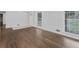 Bright living room with gleaming hardwood floors and natural light from large windows at 1110 Upper Hembree Rd, Roswell, GA 30076