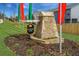 Sanders Park entrance with stone sign and colorful flag banners surrounded by well-manicured landscaping at 1205 Elowen Dr, Austell, GA 30168