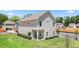 Exterior view of this home with manicured lawn, patio, and neutral colored siding at 1205 Elowen Dr, Austell, GA 30168
