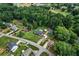 Wide aerial view showcasing home within the neighborhood, close to a large wooded area at 140 Wilbanks St, Buford, GA 30518