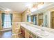 A bathroom with dual sinks, a large mirror, and colorful cabinets at 143 Cotton Mill Dr, Hiram, GA 30141
