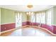 Elegant dining room with hardwood floors, a classic chandelier, and natural light from large windows at 143 Cotton Mill Dr, Hiram, GA 30141