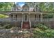 Charming two-story home featuring a welcoming front porch, neutral siding and well-maintained landscaping at 143 Cotton Mill Dr, Hiram, GA 30141