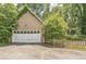 A large two-car garage with an adjacent fenced yard offers both functionality and curb appeal at 143 Cotton Mill Dr, Hiram, GA 30141