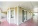 Spacious covered porch featuring a stained wood floor, multiple windows, and classic design elements at 143 Cotton Mill Dr, Hiram, GA 30141