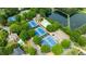 Gorgeous aerial of the community pool, tennis courts, parking, pond, and lush landscaping at 6695 Buckingham Cir, Cumming, GA 30040
