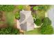An aerial shot of the property showing the roof line, mature trees, and manicured lawn at 6695 Buckingham Cir, Cumming, GA 30040