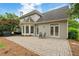View of the brick patio, exterior, and doors to the backyard of the home at 6695 Buckingham Cir, Cumming, GA 30040