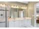 Bright primary bathroom with dual sinks and a walk-in glass shower at 6695 Buckingham Cir, Cumming, GA 30040