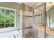 Bright primary bathroom featuring a soaking tub with a glass shower at 6695 Buckingham Cir, Cumming, GA 30040
