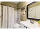 Bathroom with tub and shower combination, single vanity, and framed mirror at 6695 Buckingham Cir, Cumming, GA 30040