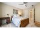 Inviting bedroom boasts a wooden bed frame, ceiling fan, and neutral decor at 6695 Buckingham Cir, Cumming, GA 30040