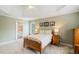 Bright bedroom with a trey ceiling and view of an ensuite bathroom at 6695 Buckingham Cir, Cumming, GA 30040