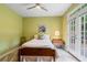Bedroom with a ceiling fan, neutral walls, and French doors to the backyard at 6695 Buckingham Cir, Cumming, GA 30040