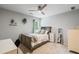 Cozy bedroom with soft gray walls, ceiling fan, and plush carpeting at 6695 Buckingham Cir, Cumming, GA 30040