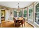 Bright breakfast nook featuring a wooden table and plenty of windows with backyard views at 6695 Buckingham Cir, Cumming, GA 30040
