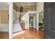 Inviting foyer with hardwood floors, a grand staircase, and ample natural light at 6695 Buckingham Cir, Cumming, GA 30040