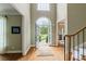 Bright and airy foyer featuring hardwood floors, a high ceiling, and views of the front yard at 6695 Buckingham Cir, Cumming, GA 30040