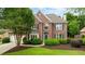 Charming two-story brick home boasting a manicured lawn and inviting curb appeal at 6695 Buckingham Cir, Cumming, GA 30040