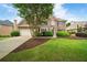 Attractive brick home featuring an attached garage and manicured landscaping, adding to its charm at 6695 Buckingham Cir, Cumming, GA 30040