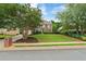 Brick two-story home with a well-manicured lawn and mature trees, enhancing curb appeal at 6695 Buckingham Cir, Cumming, GA 30040
