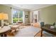Inviting living room with hardwood floors and lots of natural light through large windows at 6695 Buckingham Cir, Cumming, GA 30040