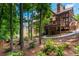 Expansive backyard with a covered porch, lower-level patio, and lush landscaping at 9967 Devonshire St, Douglasville, GA 30135