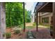 Lush backyard featuring mature trees, landscaped gardens, and a stone path at 9967 Devonshire St, Douglasville, GA 30135