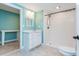 Bathroom featuring blue walls, white vanity, walk in shower, and gray tile flooring at 9967 Devonshire St, Douglasville, GA 30135