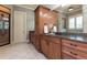 Spacious bathroom with double sinks, wood cabinets, granite counters, and tile floors at 9967 Devonshire St, Douglasville, GA 30135