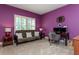 Bedroom with purple walls, futon, desk and window with blinds at 9967 Devonshire St, Douglasville, GA 30135