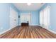 This bedroom features hardwood floors, blue walls, and ample natural light at 9967 Devonshire St, Douglasville, GA 30135