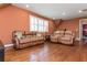 Spacious bonus room with hardwood floors, ample seating, and a view to an additional room at 9967 Devonshire St, Douglasville, GA 30135