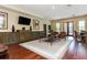 Clubhouse lounge area with hardwood floors, stylish furniture and large windows at 9967 Devonshire St, Douglasville, GA 30135