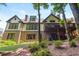 View of the home's exterior featuring a large deck, walkout basement and landscaped yard at 9967 Devonshire St, Douglasville, GA 30135