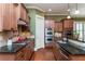Kitchen featuring stainless steel appliances, granite countertops, wood cabinets, and tile backsplash at 9967 Devonshire St, Douglasville, GA 30135