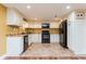 Kitchen with white cabinets, black appliances, and tile flooring at 9967 Devonshire St, Douglasville, GA 30135
