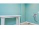 Bright laundry room features blue walls, white trim, and a convenient folding table at 9967 Devonshire St, Douglasville, GA 30135