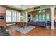 Open floor plan living room with a fireplace, hardwood floors, and a view of the backyard at 9967 Devonshire St, Douglasville, GA 30135