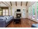 Open living space features hardwood floors, a fireplace, and access to the outdoor deck with natural lighting at 9967 Devonshire St, Douglasville, GA 30135